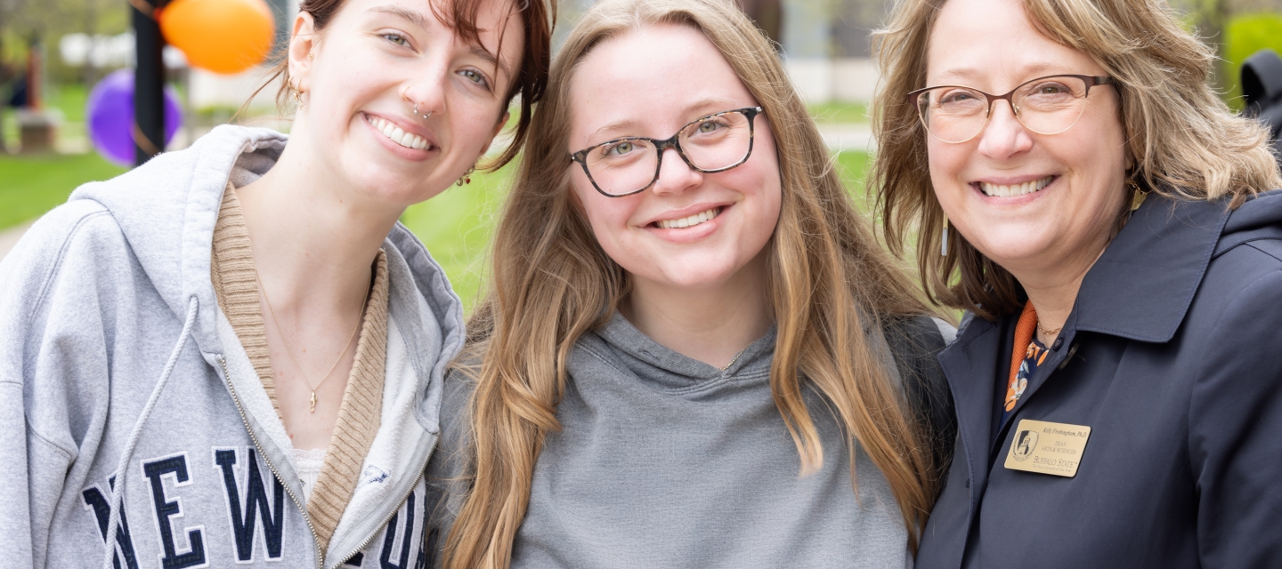 students_smiling_with_adult_woman